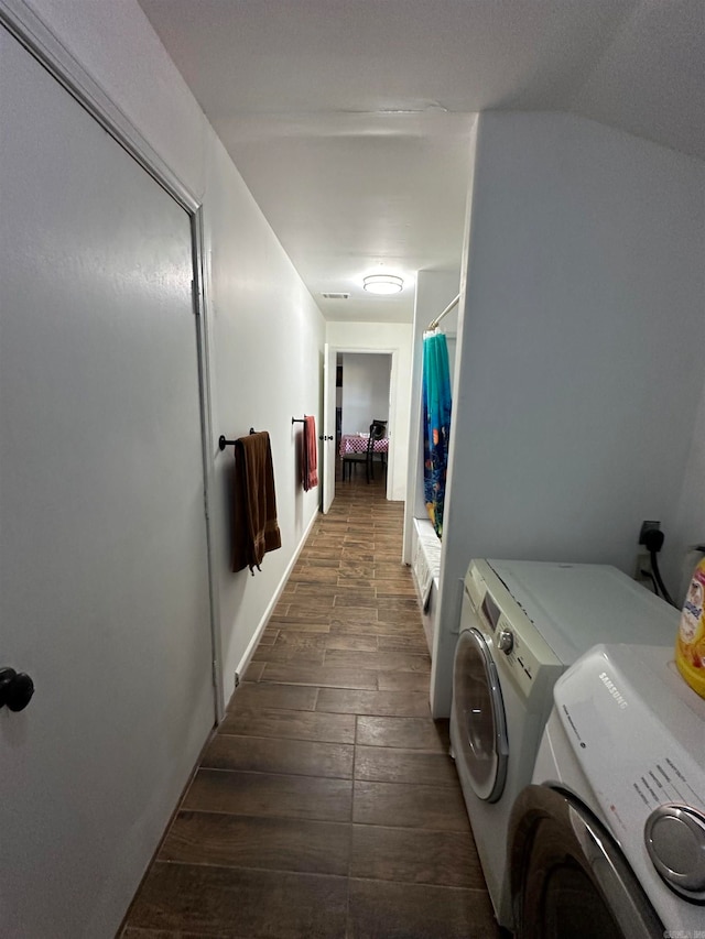 laundry room featuring dark wood-type flooring and washing machine and dryer