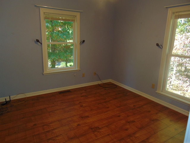 unfurnished room featuring wood-type flooring