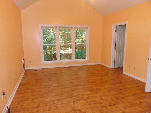 unfurnished room with lofted ceiling and light hardwood / wood-style flooring