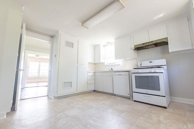 kitchen with white appliances, extractor fan, white cabinets, and sink