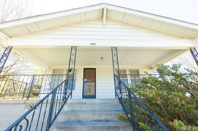 view of exterior entry with covered porch