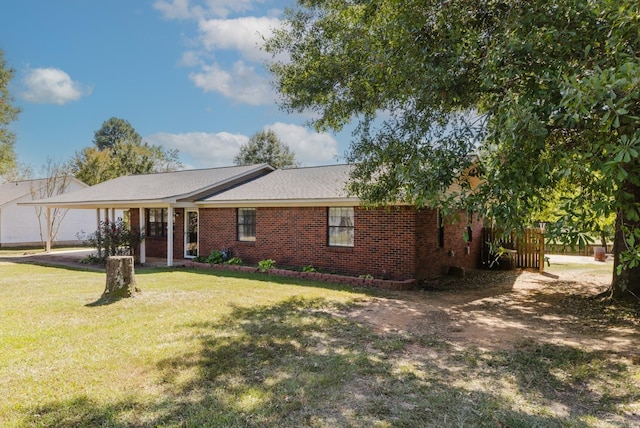 ranch-style house with a front lawn and a carport