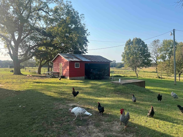 view of yard featuring an outbuilding and a rural view