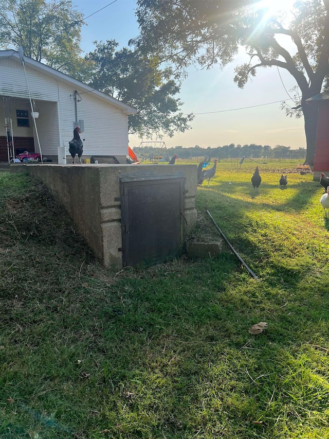 yard at dusk with a rural view