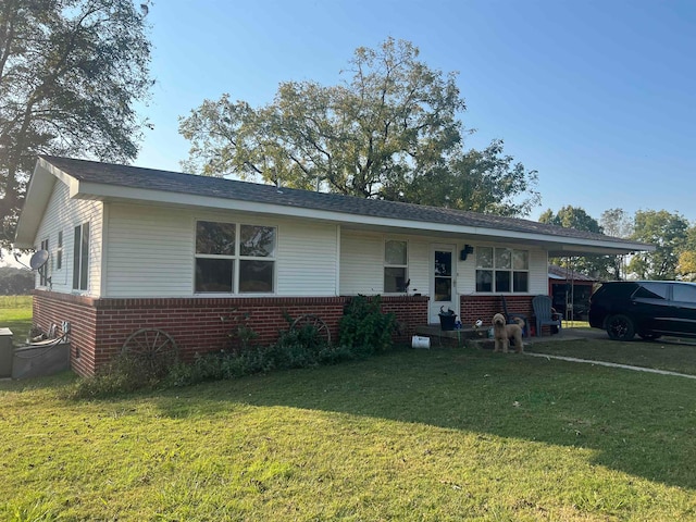 single story home featuring a front lawn and a carport