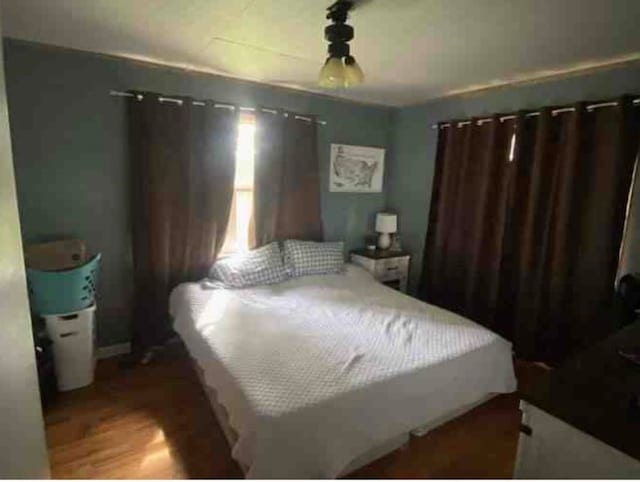 bedroom featuring dark hardwood / wood-style flooring