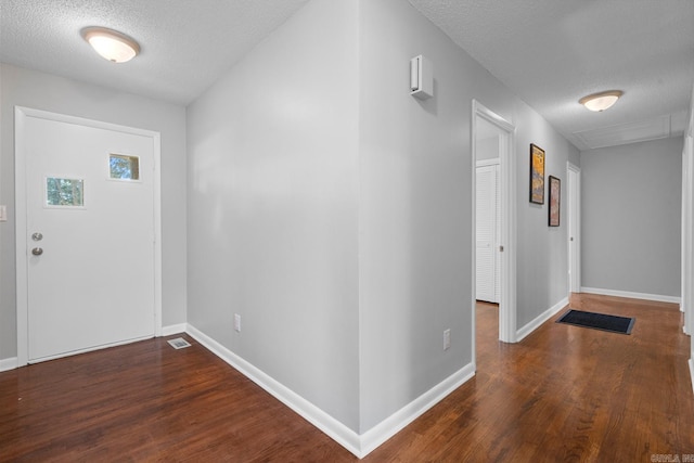 entryway featuring dark hardwood / wood-style floors and a textured ceiling