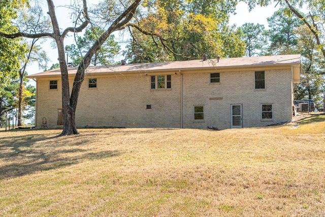 back of property featuring a yard