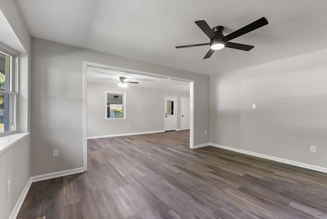 spare room with ceiling fan and dark hardwood / wood-style floors