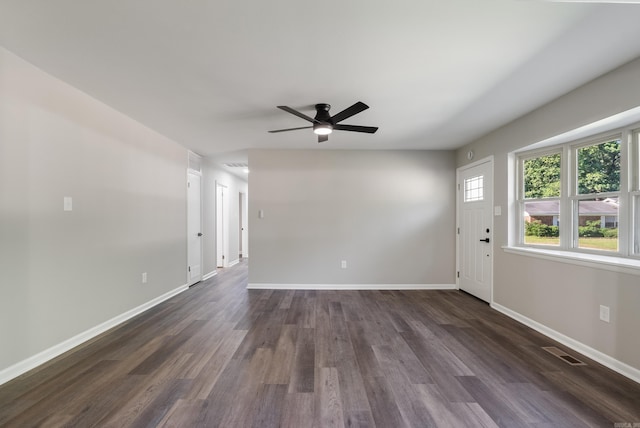 spare room featuring ceiling fan and dark wood-type flooring