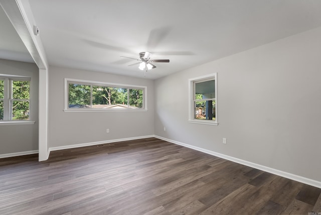 spare room with ceiling fan and dark hardwood / wood-style floors