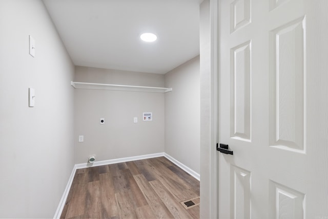 clothes washing area with hookup for a washing machine, hardwood / wood-style floors, and electric dryer hookup