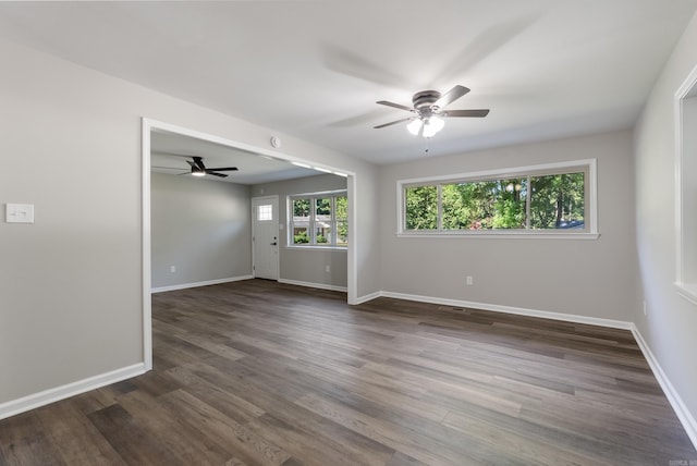 spare room featuring ceiling fan and dark hardwood / wood-style flooring