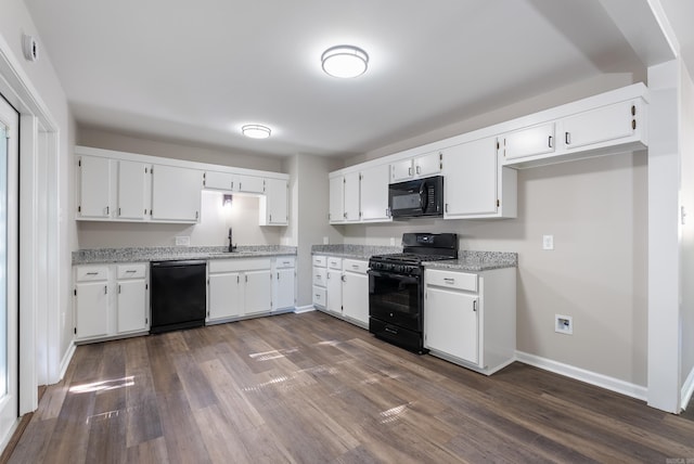 kitchen with sink, white cabinetry, dark hardwood / wood-style flooring, and black appliances