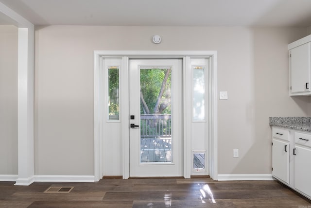 doorway with dark wood-type flooring