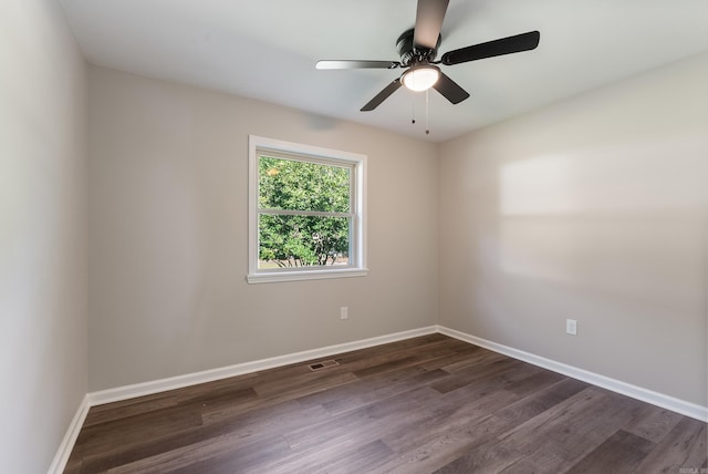 empty room with dark hardwood / wood-style flooring and ceiling fan