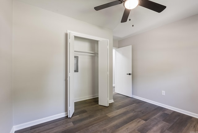 unfurnished bedroom featuring dark wood-type flooring, a closet, and ceiling fan