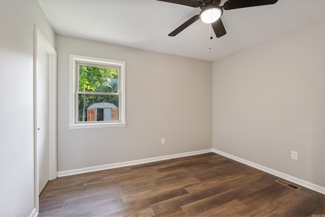 spare room with ceiling fan and dark wood-type flooring