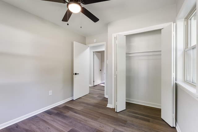 unfurnished bedroom with ceiling fan, a closet, and dark hardwood / wood-style flooring