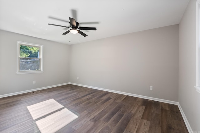 unfurnished room with ceiling fan and dark hardwood / wood-style floors