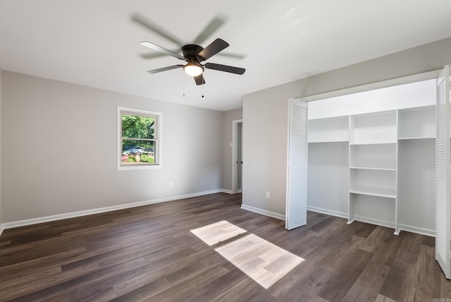 unfurnished bedroom featuring a closet, dark hardwood / wood-style floors, and ceiling fan