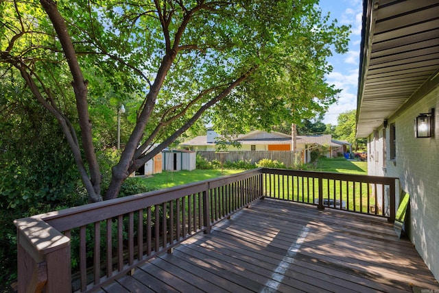 wooden terrace featuring a yard and a storage shed