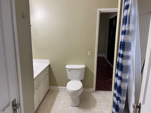 bathroom featuring tile patterned floors, vanity, and toilet