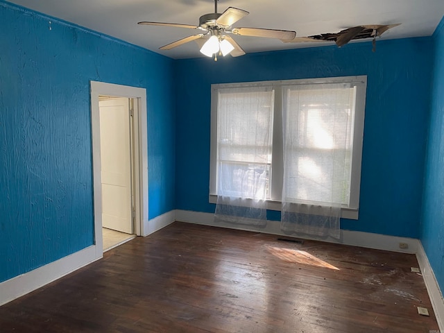 spare room with ceiling fan and dark wood-type flooring