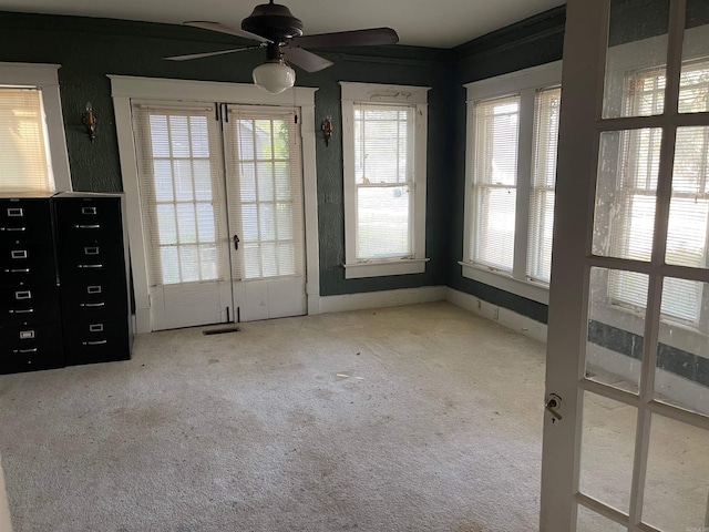 interior space with ceiling fan and french doors