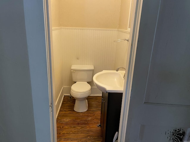 bathroom featuring hardwood / wood-style floors, vanity, and toilet