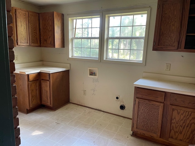 washroom with hookup for a washing machine, cabinets, and hookup for an electric dryer