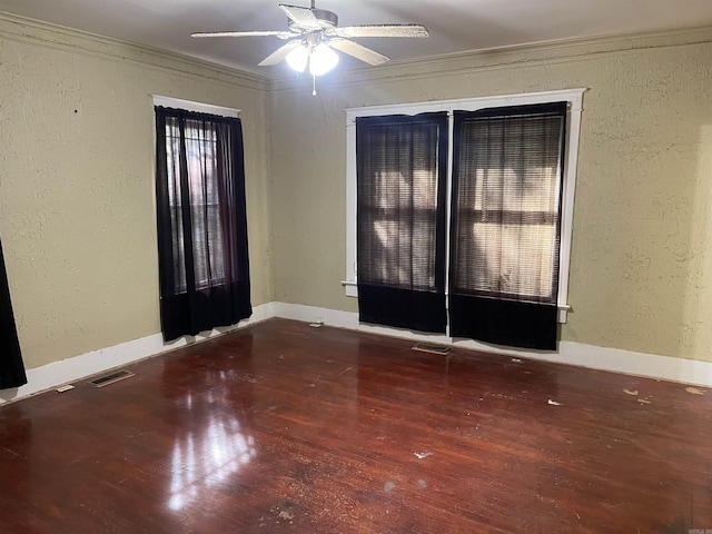 unfurnished room featuring crown molding, dark hardwood / wood-style flooring, and ceiling fan