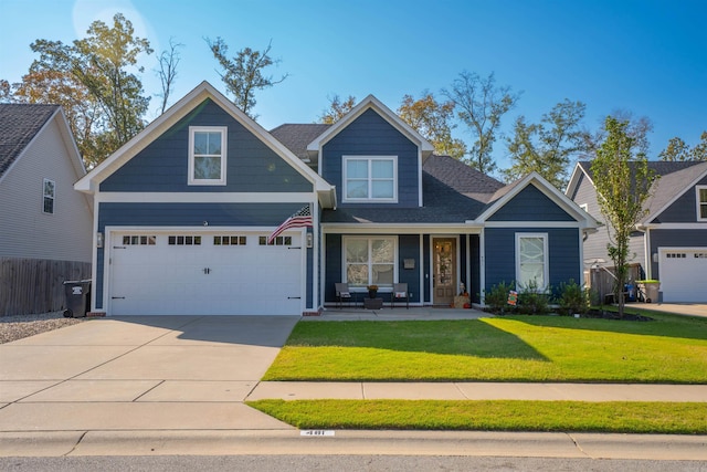 craftsman inspired home with a front yard and a garage