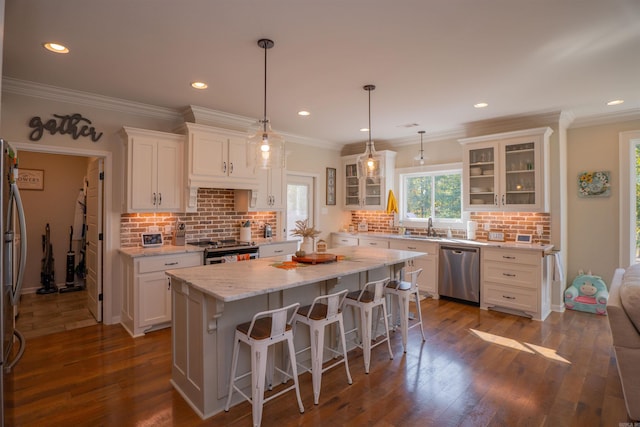 kitchen featuring appliances with stainless steel finishes, white cabinets, and dark hardwood / wood-style flooring