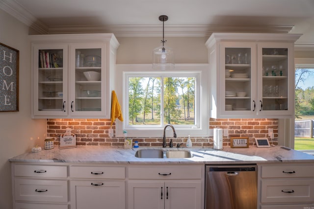 kitchen with sink, dishwasher, white cabinetry, and hanging light fixtures