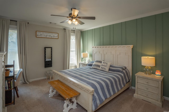 carpeted bedroom with multiple windows, ornamental molding, and ceiling fan