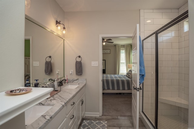 bathroom with vanity, a shower with shower door, and ceiling fan