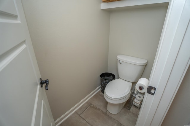 bathroom with toilet and tile patterned flooring