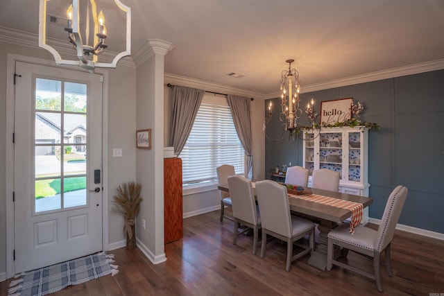 dining area with dark wood-type flooring, crown molding, and an inviting chandelier