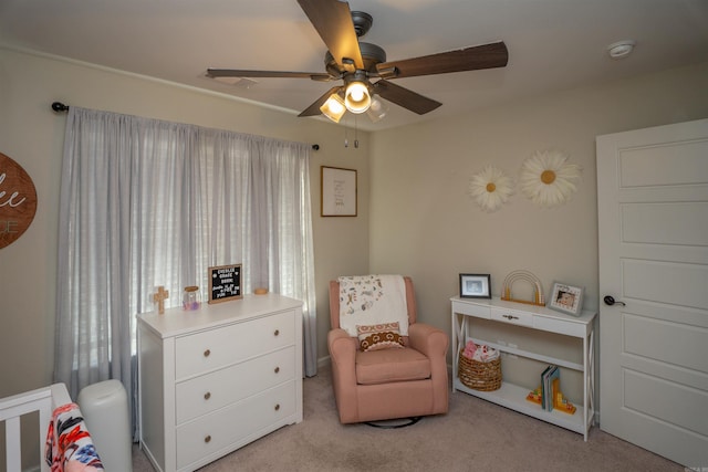 living area with light carpet and ceiling fan