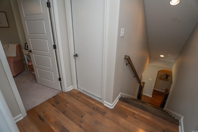 staircase with wood-type flooring