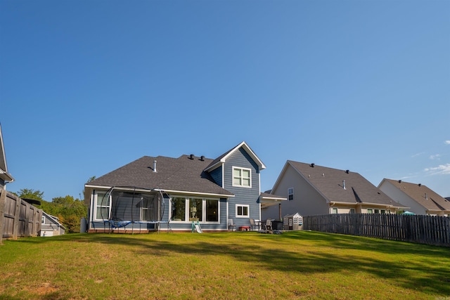 back of house with a patio area, a lawn, and a sunroom