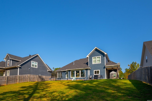 rear view of house featuring a patio area and a lawn