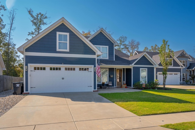 craftsman inspired home featuring a front yard and a garage