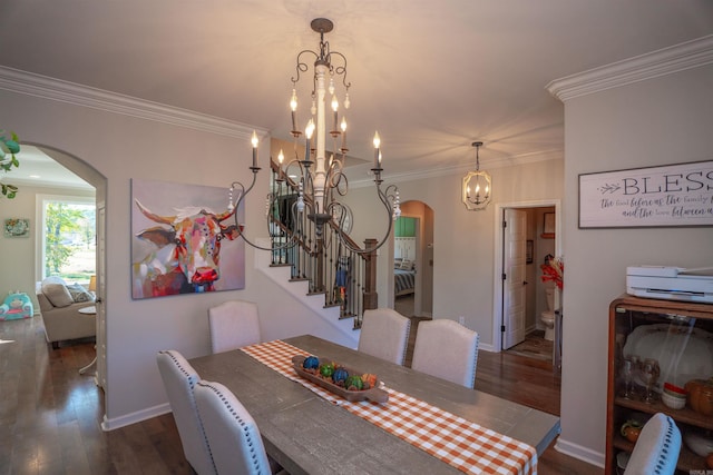 dining area featuring an inviting chandelier, crown molding, and dark wood-type flooring