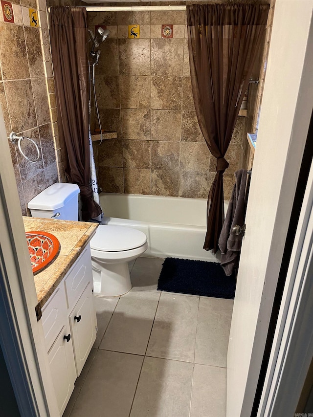 full bathroom with tile patterned floors, vanity, shower / bath combo with shower curtain, and toilet