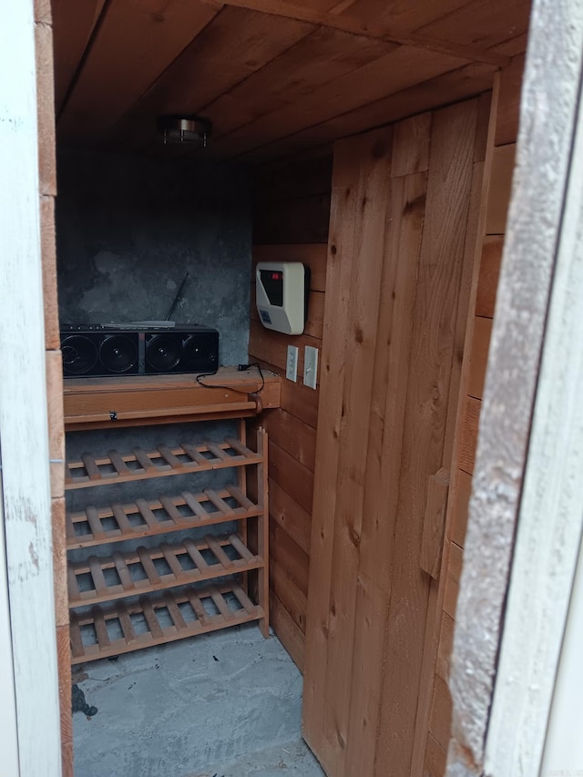 wine cellar featuring wood walls and concrete flooring