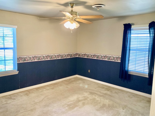 unfurnished room featuring carpet floors and ceiling fan