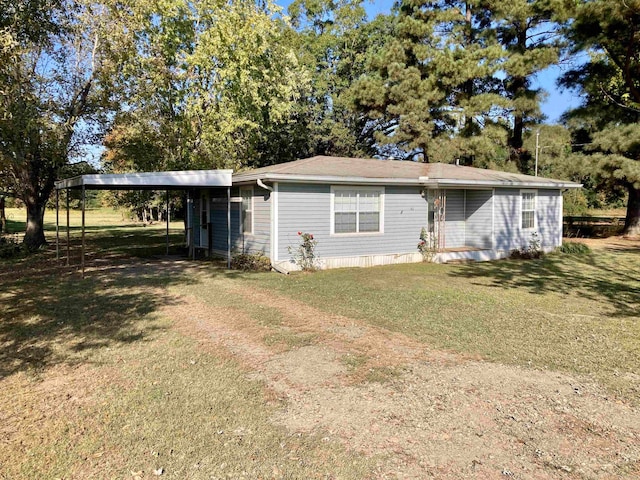 view of front of house with a front yard and a carport