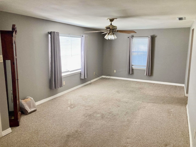 carpeted empty room featuring ceiling fan